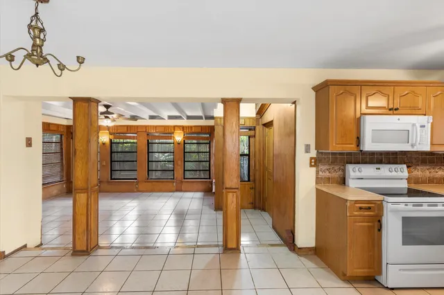 a kitchen with stainless steel appliances granite countertop a refrigerator and a stove