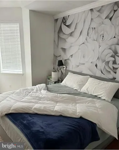 a bedroom with a bed and a window