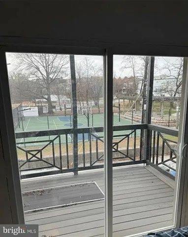 a view of a floor to ceiling window and wooden floor