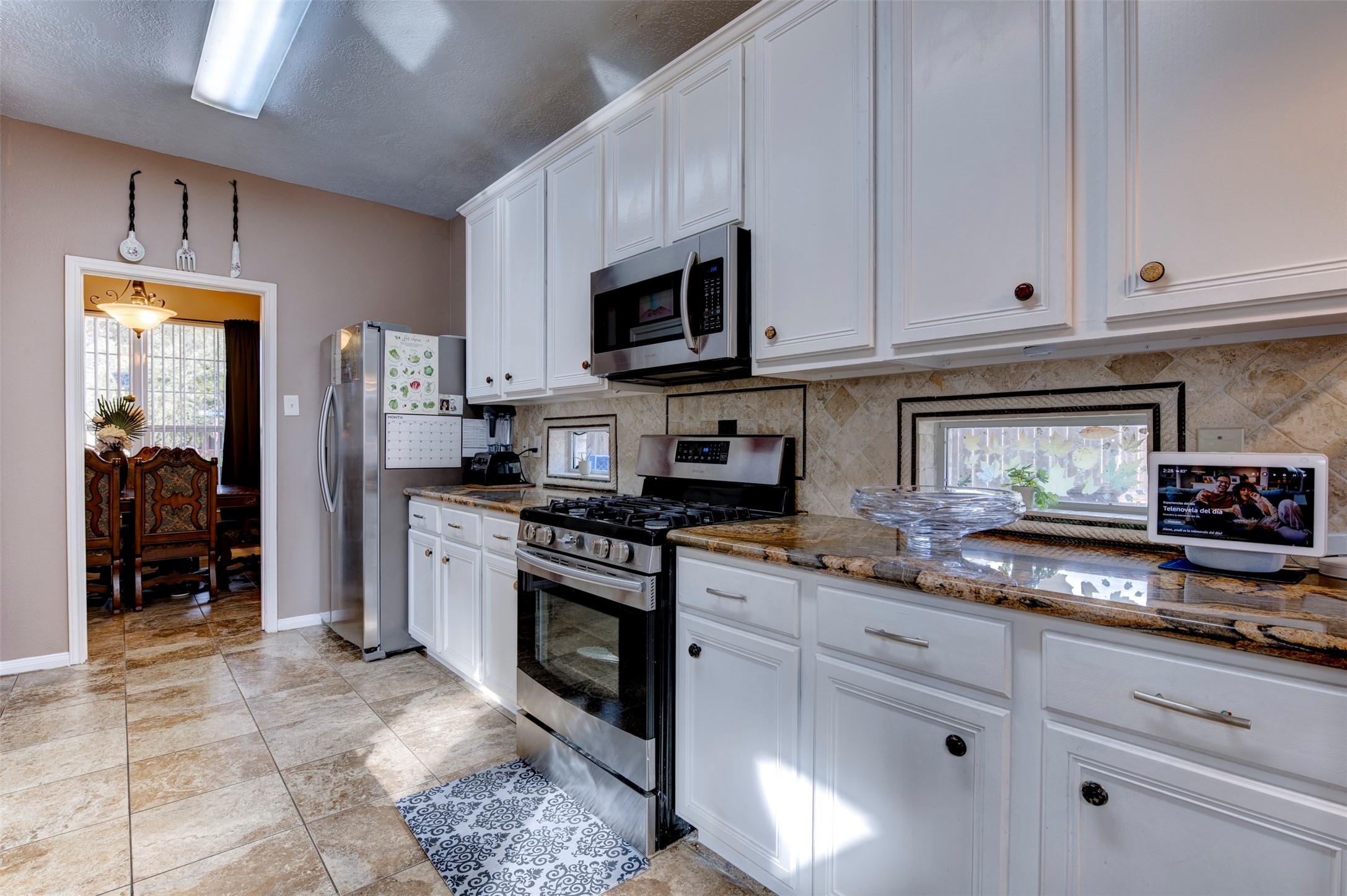 9214 Windy Spring Court Houston, TX 77089 - Photo 18 of 50 a kitchen with stainless steel appliances granite countertop a stove a sink and a refrigerator