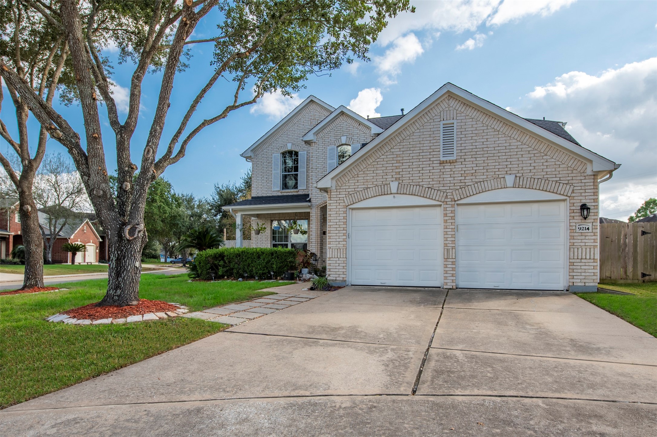 9214 Windy Spring Court Houston, TX 77089 - Photo 3 of 50 a front view of a house with a yard and trees