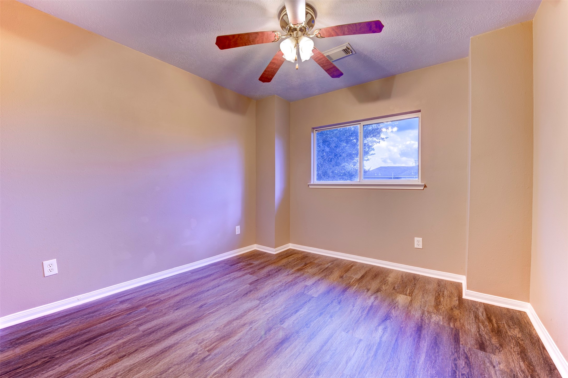 9214 Windy Spring Court Houston, TX 77089 - Photo 32 of 50 a view of an empty room with window and wooden floor