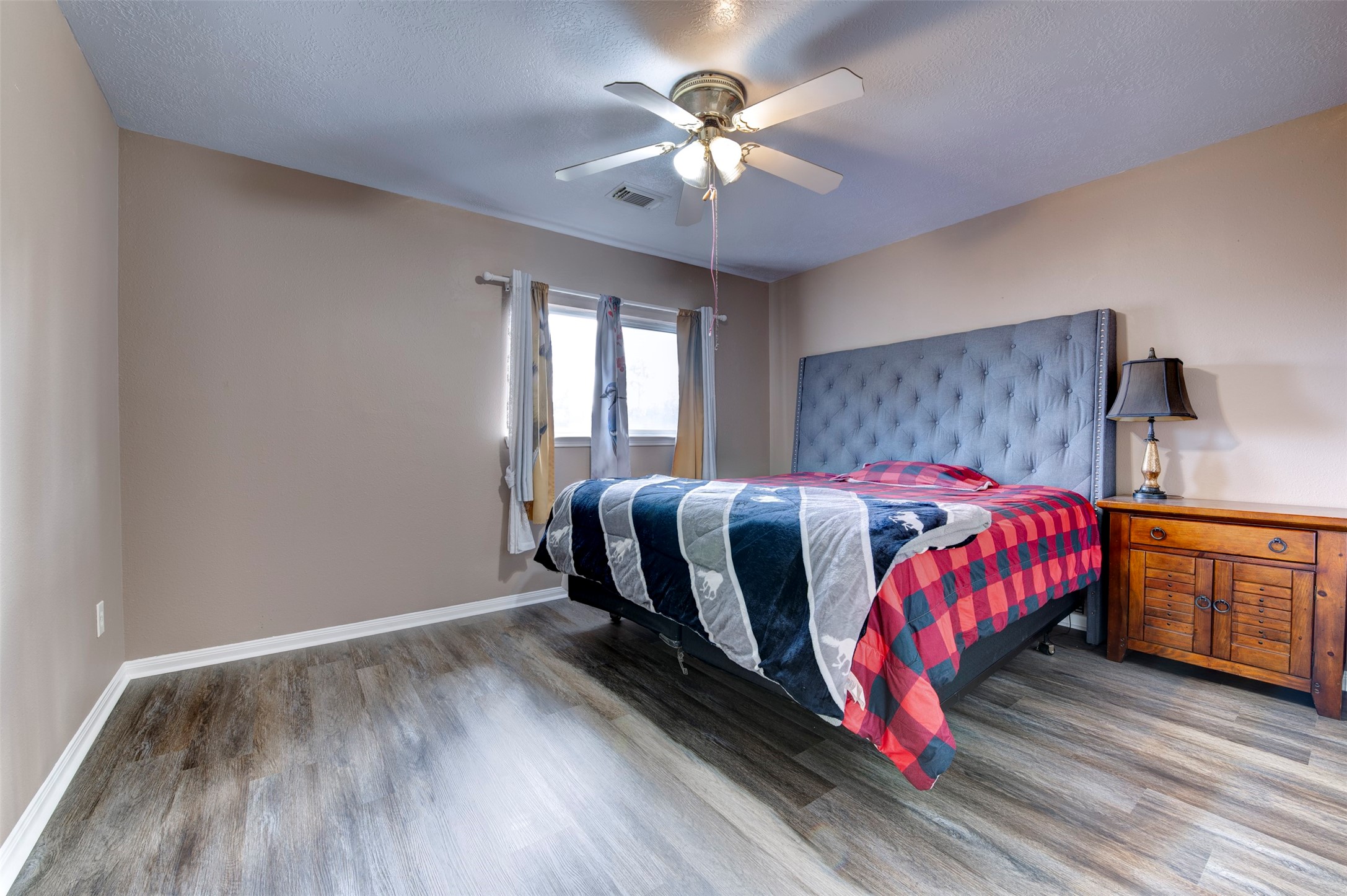 9214 Windy Spring Court Houston, TX 77089 - Photo 39 of 50 a bedroom with a bed and a ceiling fan