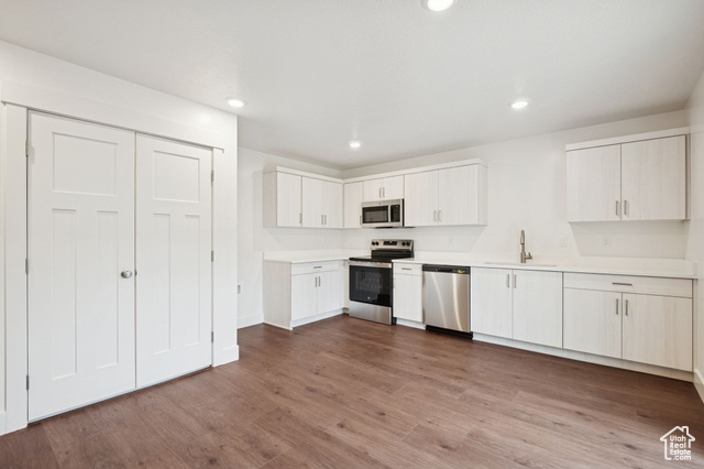 1615 North Angel Street, Unit F Layton, UT 84041 - Photo 5 of 45 Kitchen with stainless steel appliances, light countertops, dark wood-style floors, white cabinetry, and recessed lighting