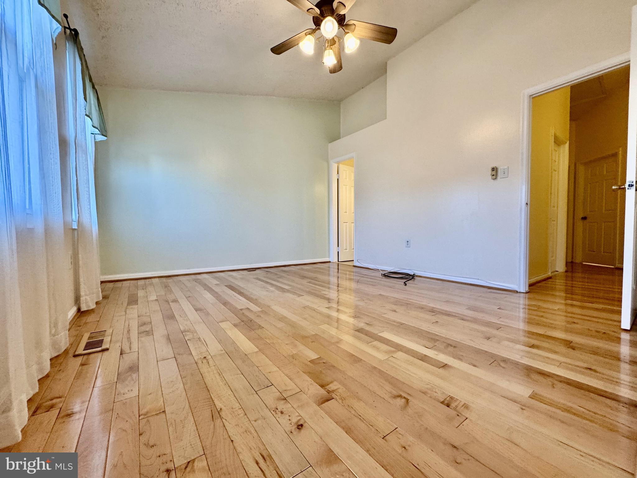 306 Leafcup Road Gaithersburg, MD 20878 - Photo 13 of 17 wooden floor in an empty room with a window