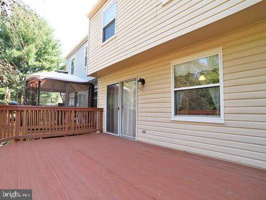 306 Leafcup Road Gaithersburg, MD 20878 - Photo 16 of 17 a view of a house with a balcony and wooden floor
