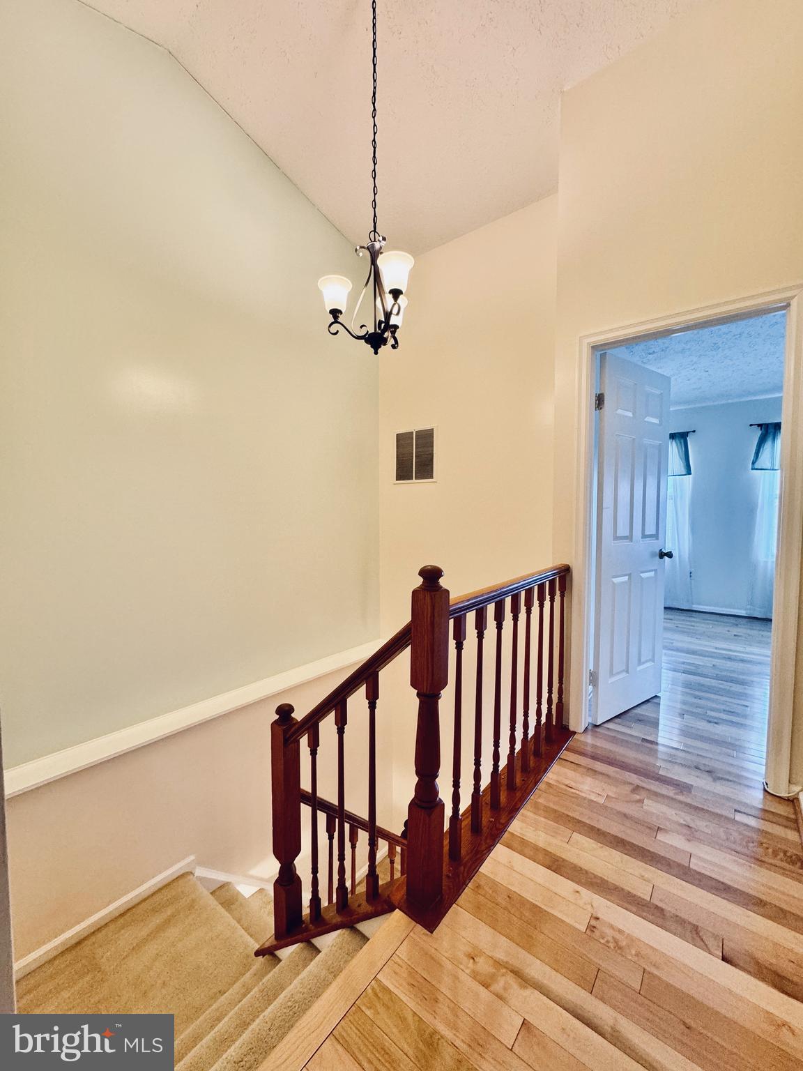 306 Leafcup Road Gaithersburg, MD 20878 - Photo 8 of 17 a view of a hallway with wooden floor and staircase