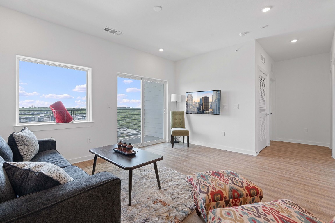 4802 South Congress Avenue, Unit 418 Austin, TX 78745 - Photo 12 of 24 a living room with furniture and a flat screen tv