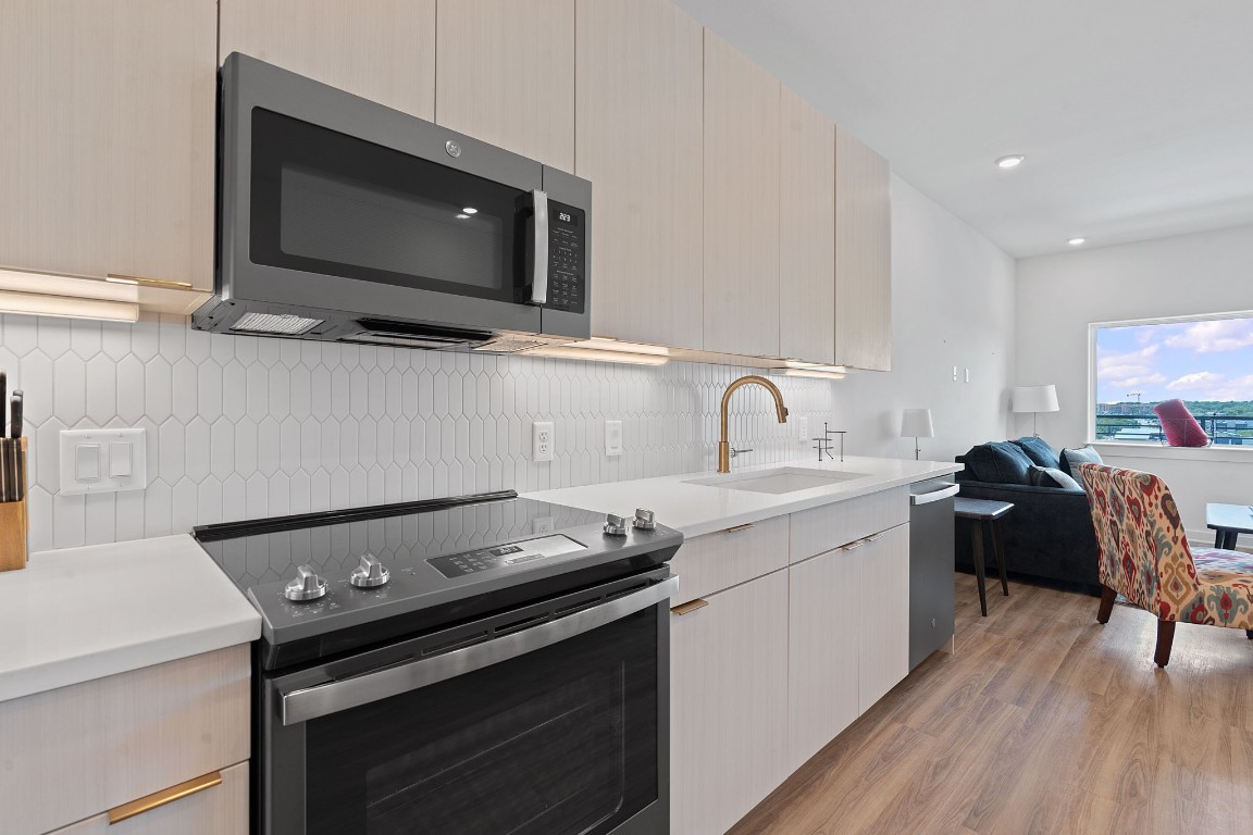 4802 South Congress Avenue, Unit 418 Austin, TX 78745 - Photo 15 of 24 a kitchen with a stove and a microwave