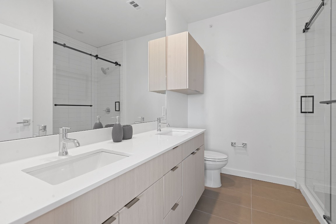 4802 South Congress Avenue, Unit 418 Austin, TX 78745 - Photo 20 of 24 a bathroom with a sink toilet and vanity