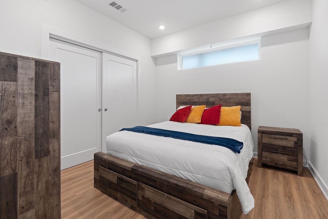 4802 South Congress Avenue, Unit 418 Austin, TX 78745 - Photo 21 of 24 a bedroom with a bed and a cabinets