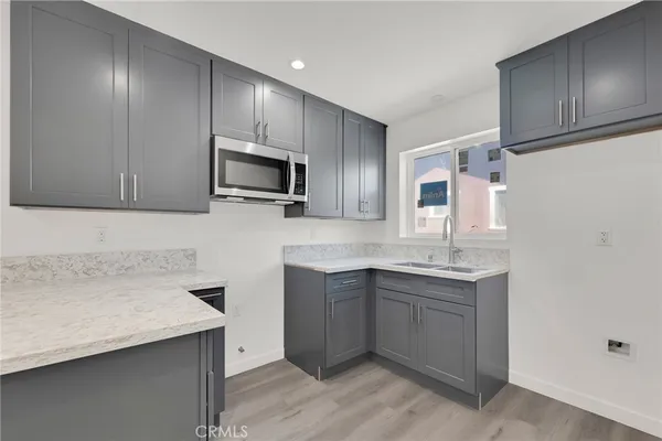 a kitchen with a sink cabinets and microwave