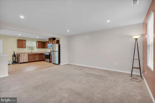an empty room with fireplace and windows