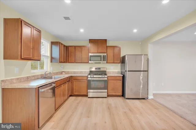 a kitchen with refrigerator cabinets and a sink