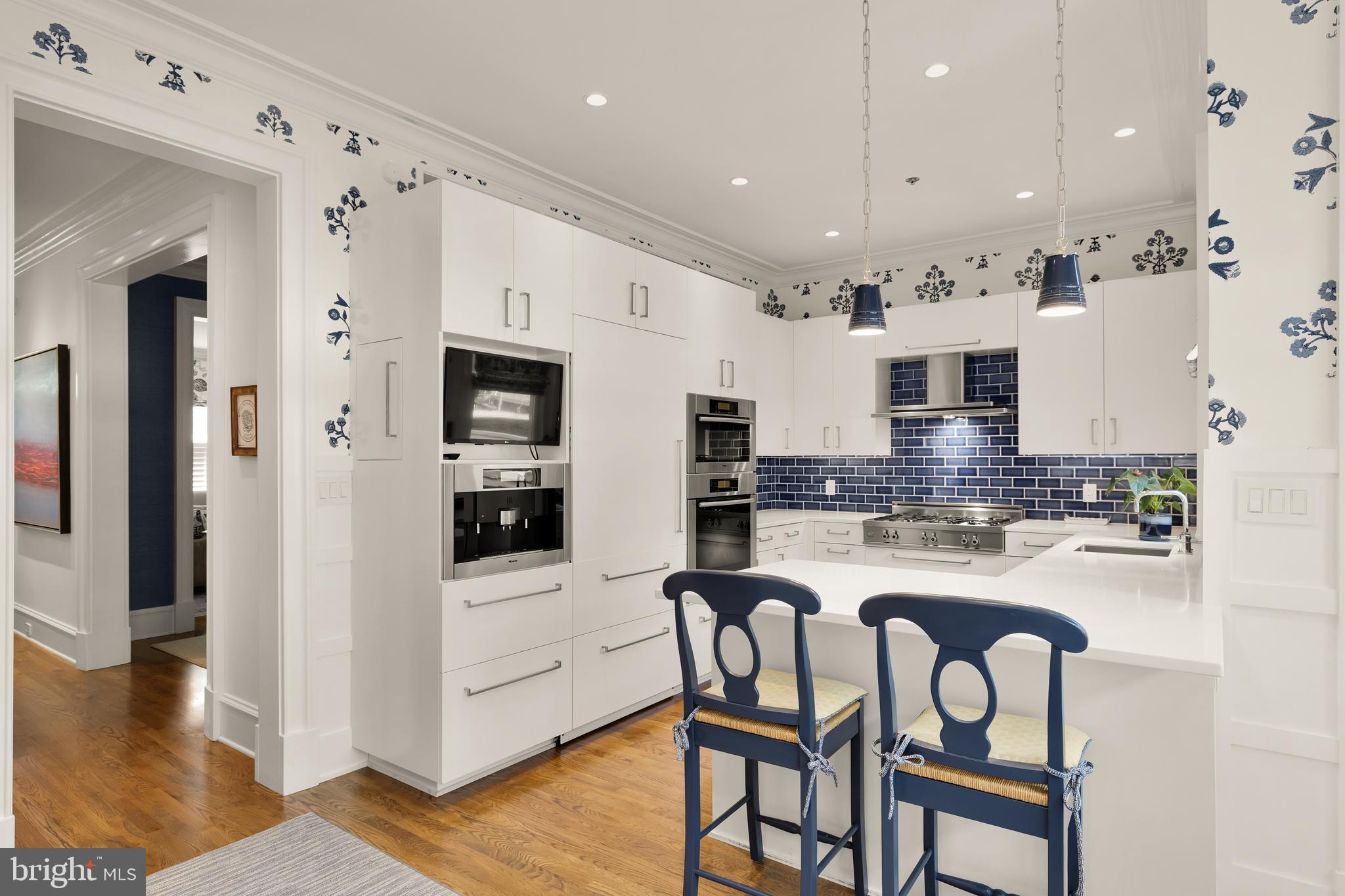 7449 Arlington Road Bethesda, MD 20814 - Photo 12 of 35 a kitchen with stainless steel appliances granite countertop a stove top oven a sink and cabinets
