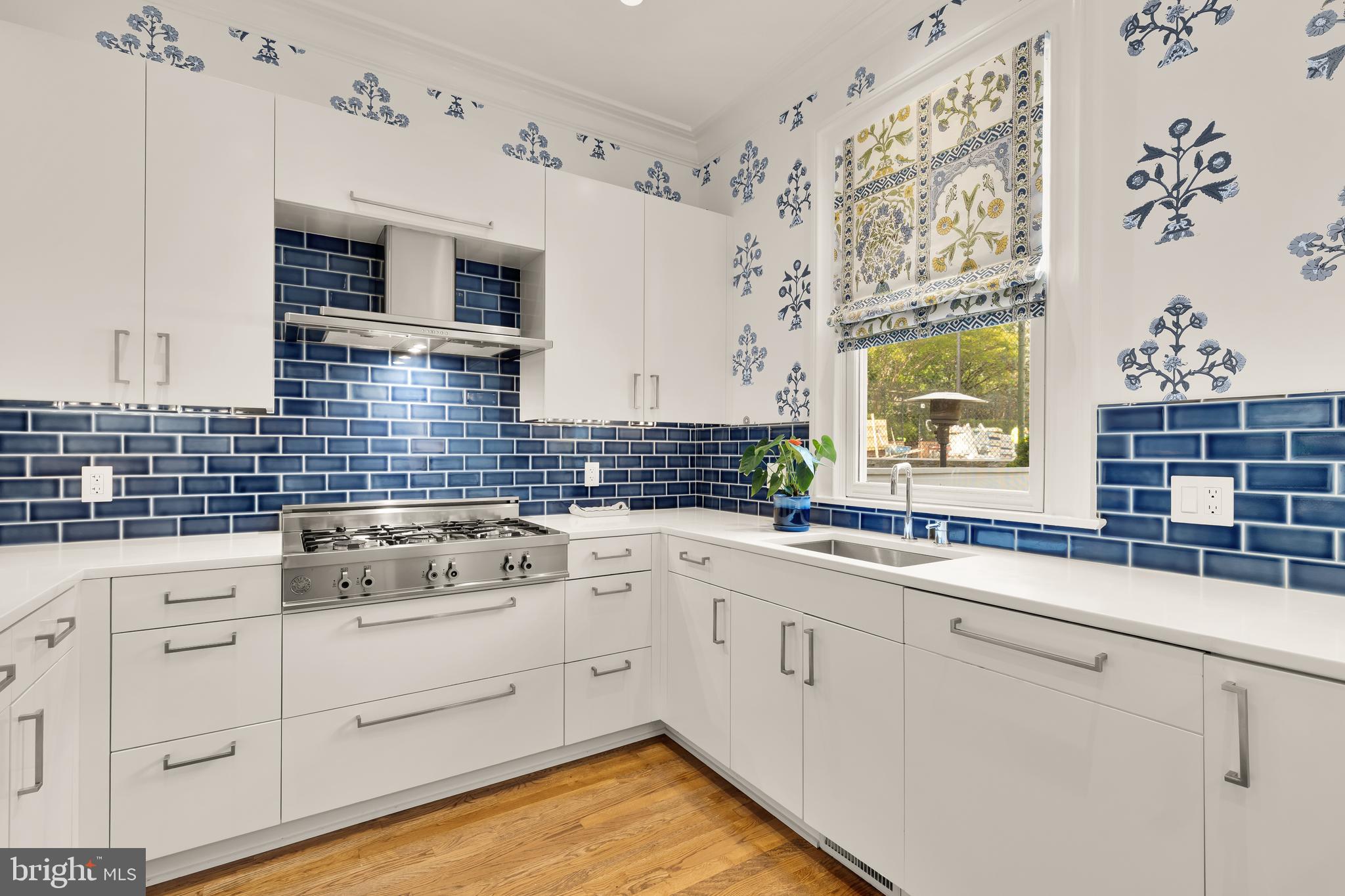 7449 Arlington Road Bethesda, MD 20814 - Photo 13 of 35 a kitchen with cabinets appliances a sink and a window