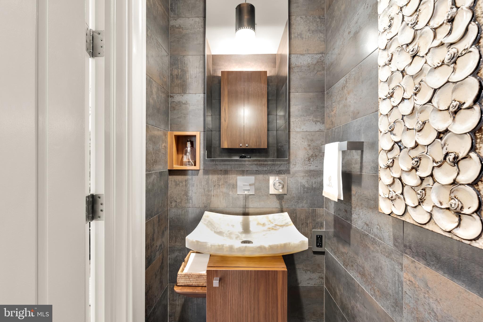 7449 Arlington Road Bethesda, MD 20814 - Photo 18 of 35 a bathroom with a sink and a mirror