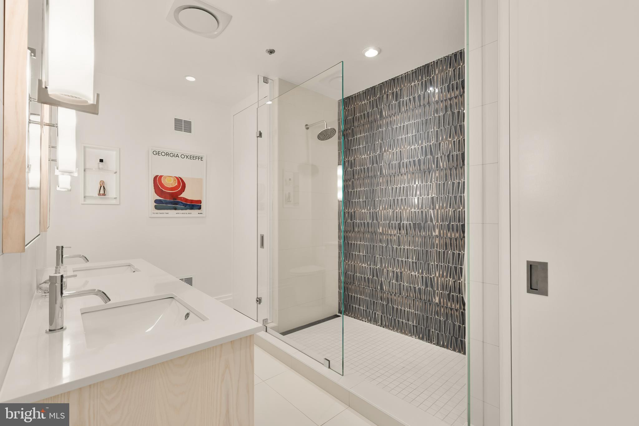 7449 Arlington Road Bethesda, MD 20814 - Photo 23 of 35 a bathroom with a sink and a shower
