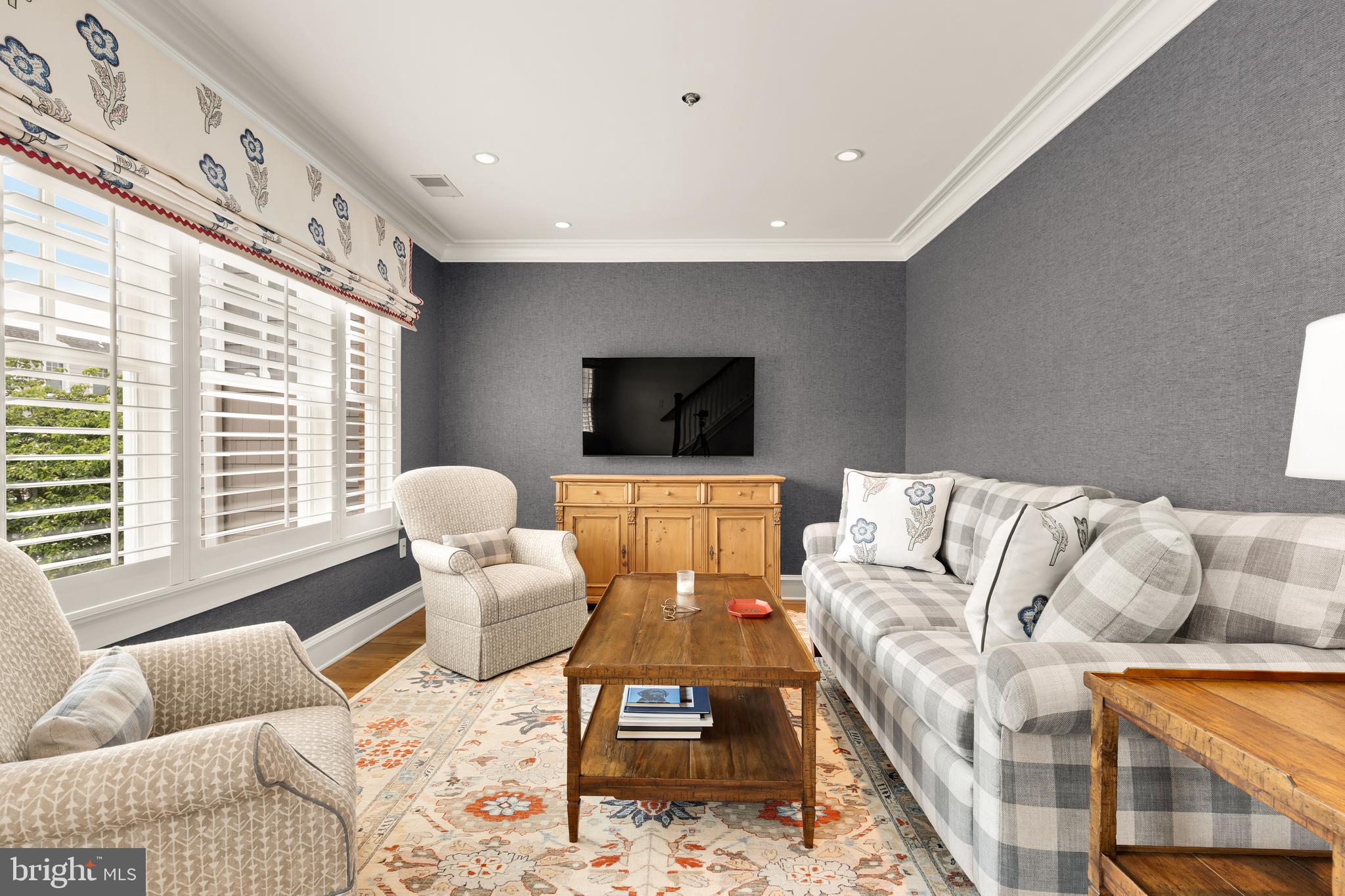 7449 Arlington Road Bethesda, MD 20814 - Photo 25 of 35 a living room with furniture and a flat screen tv