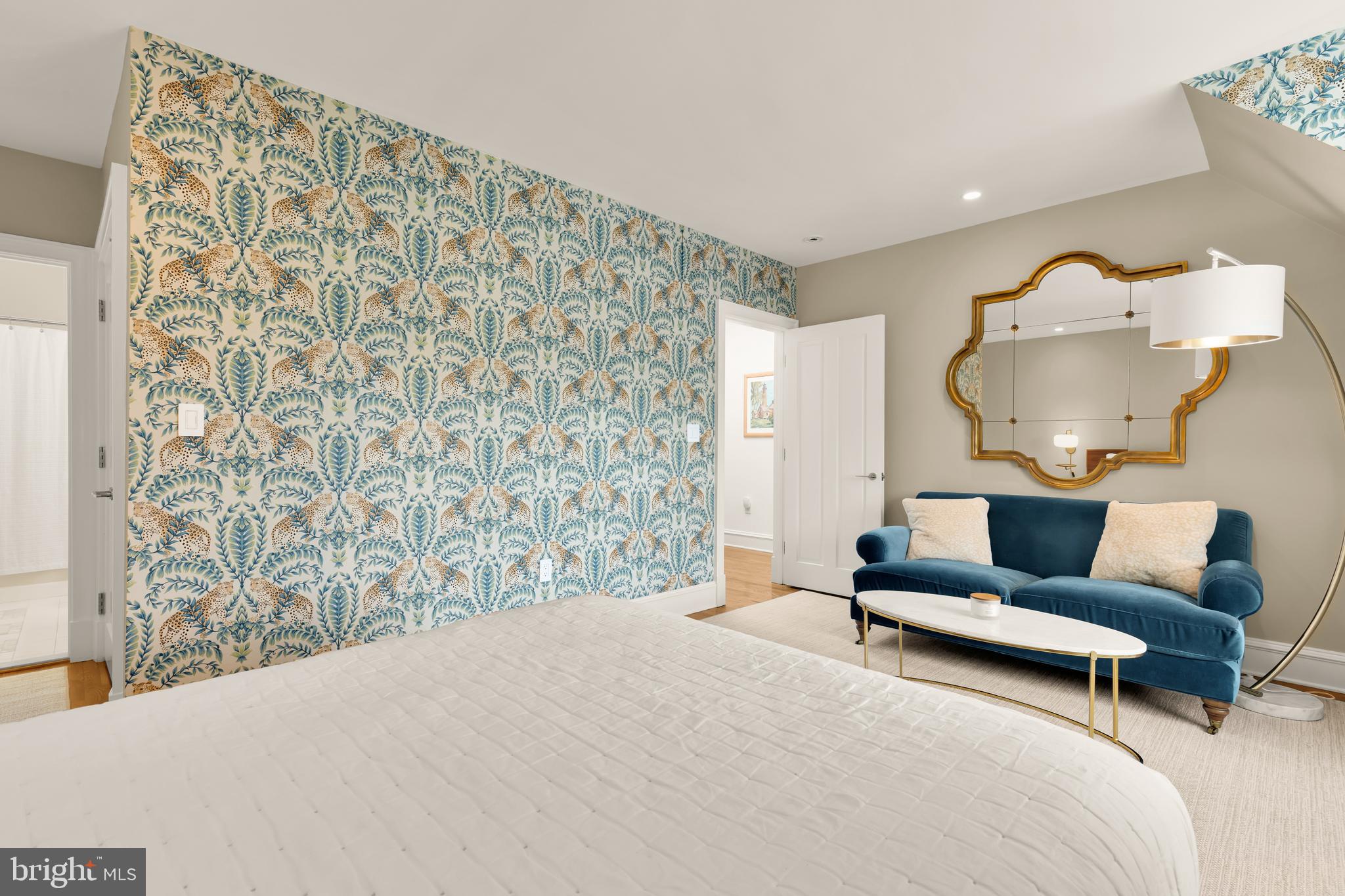 7449 Arlington Road Bethesda, MD 20814 - Photo 28 of 35 a spacious bedroom with a bed and a chandelier