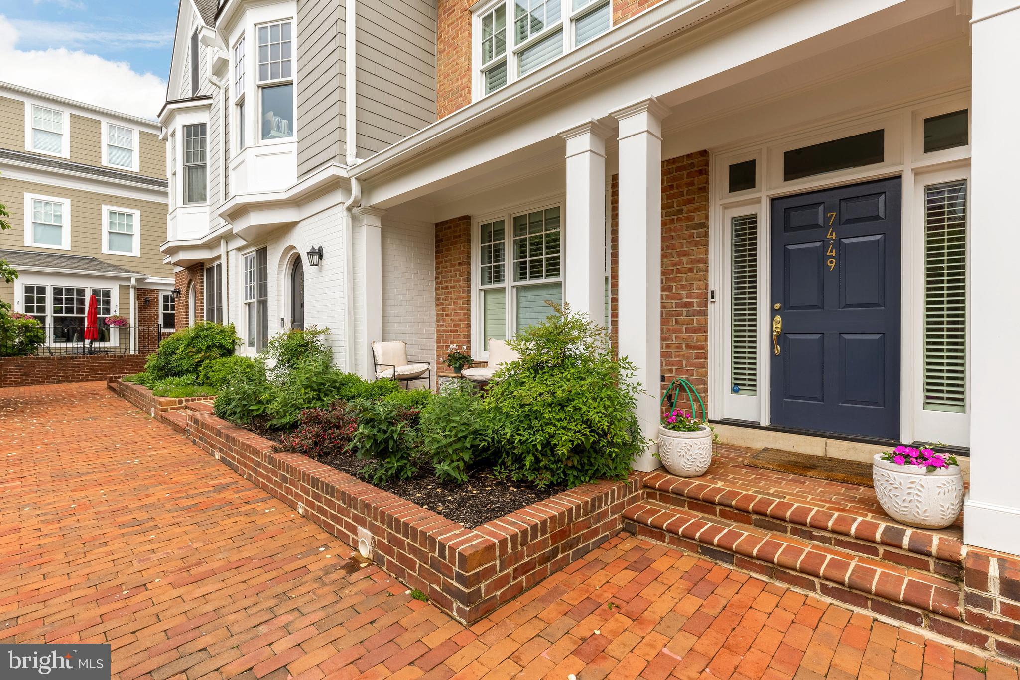 7449 Arlington Road Bethesda, MD 20814 - Photo 3 of 35 a view of a white building with potted plants in front of main door