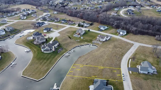 an aerial view of a house with a lake view