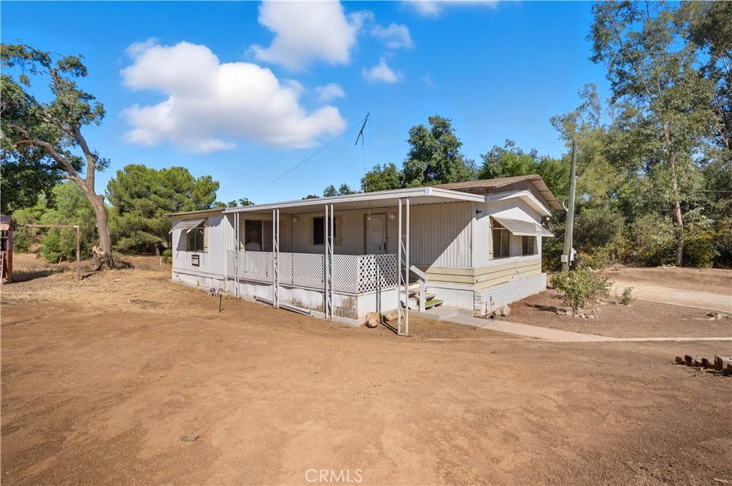 32905 Tucker Road Menifee, CA 92584 - Photo 1 of 1 a white house with a large tree in front of it