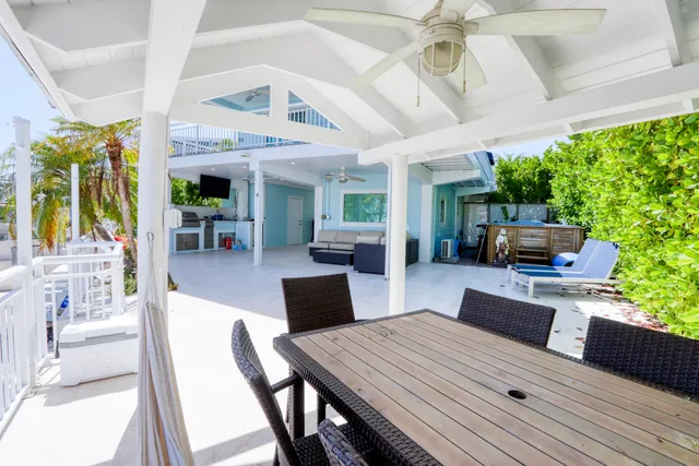 a view of a house with a yard and potted plants