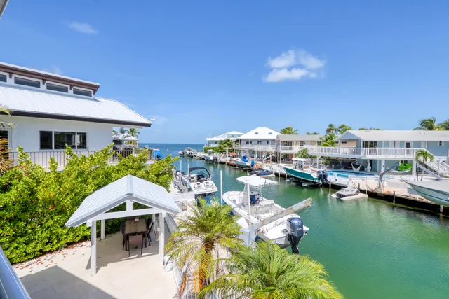 a view of a swimming pool and outdoor seating