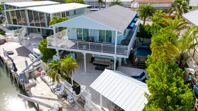 an aerial view of residential houses with outdoor space and lake view