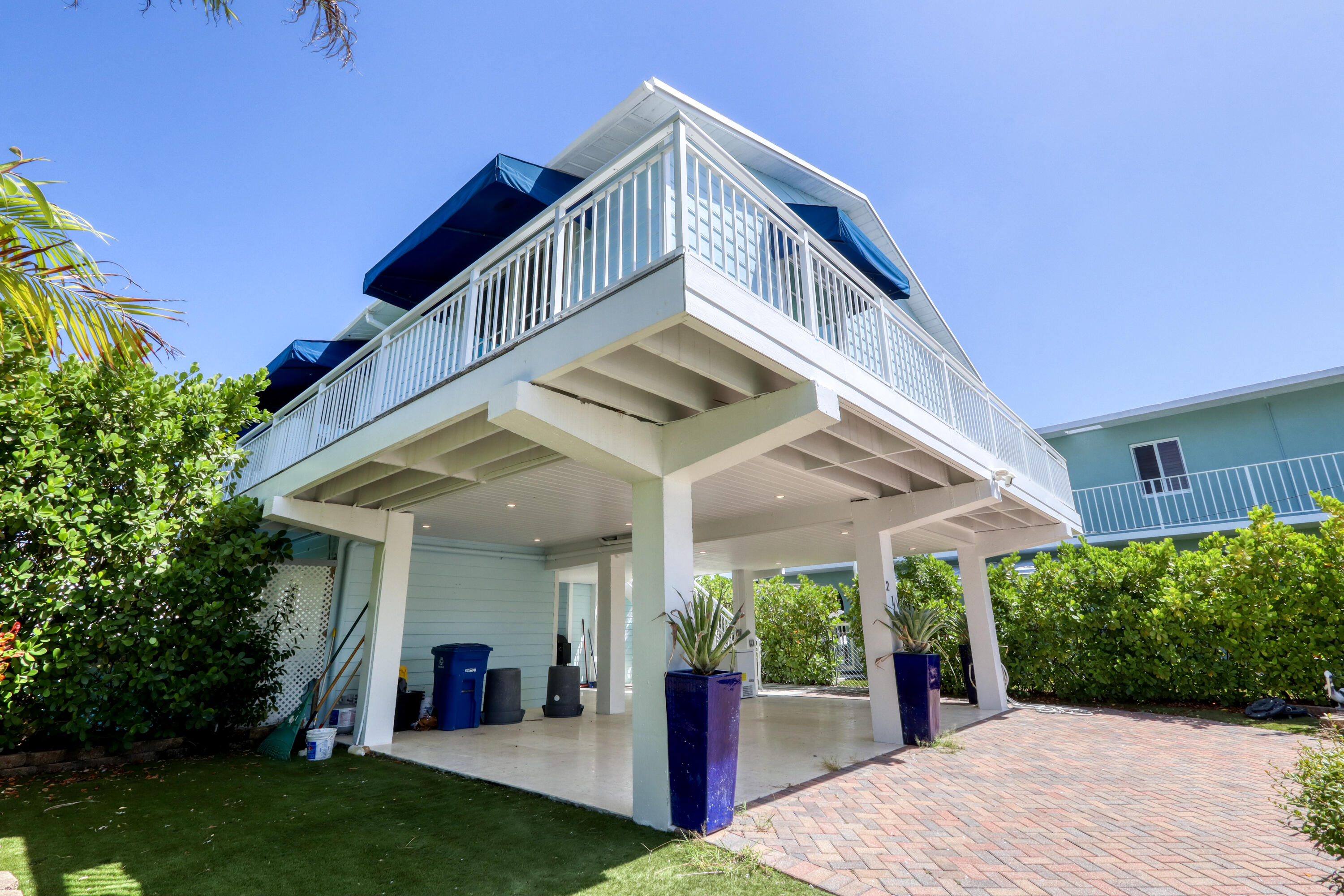 214 Aberdeen Court Tavernier, FL 33070 - Photo 26 of 81 a view of a house with a yard and potted plants