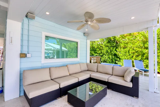 a kitchen with kitchen island a counter top space appliances and a potted plant