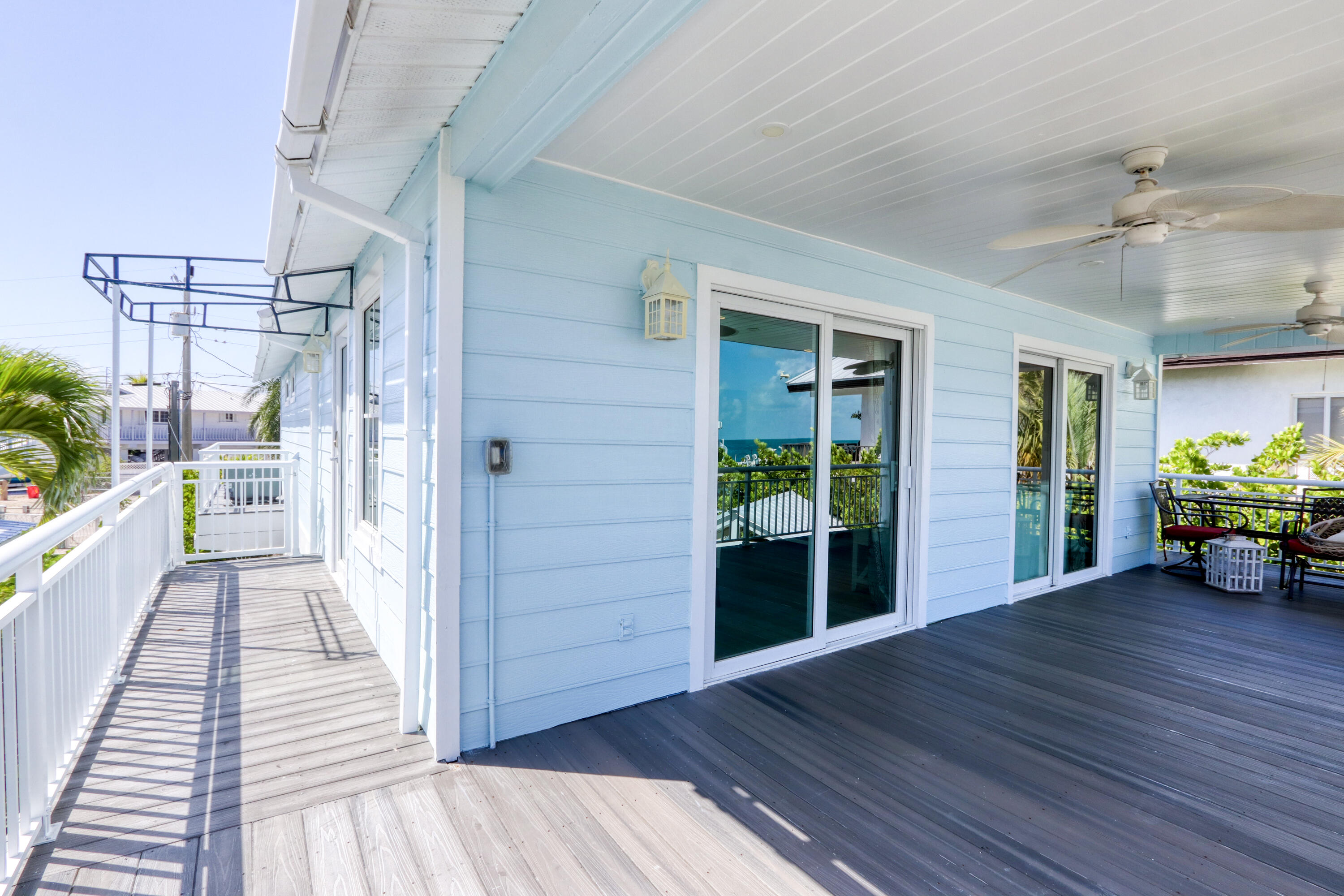 214 Aberdeen Court Tavernier, FL 33070 - Photo 34 of 81 a view of a porch with wooden floor and a potted plant