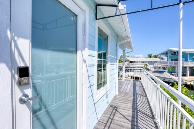 a bedroom with a bed and flat tv screen on the dresser
