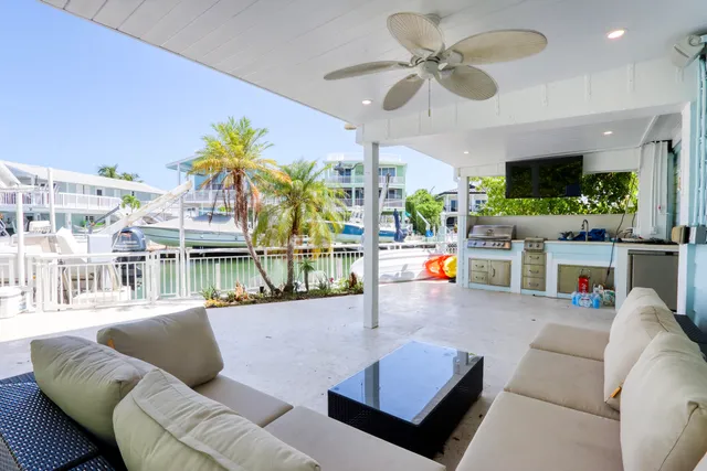 a view of a living room with a table and chairs