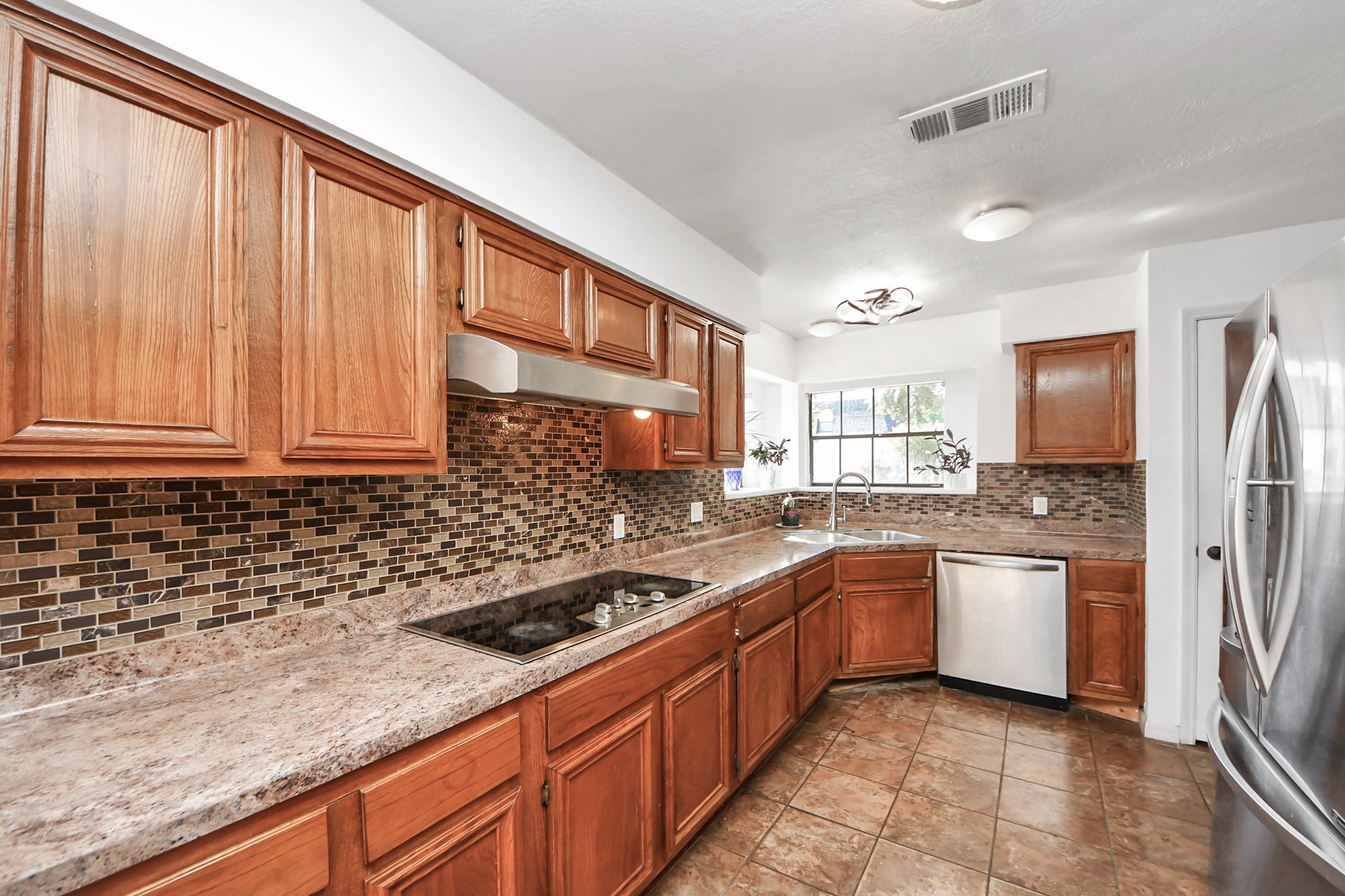 4712 Country Club View Baytown, TX 77521 - Photo 20 of 50 a kitchen with stainless steel appliances granite countertop a sink stove and refrigerator