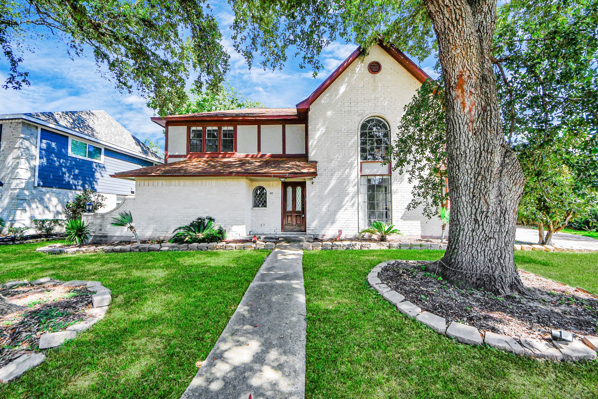 4712 Country Club View Baytown, TX 77521 - Photo 2 of 50 a front view of a house with a yard and trees