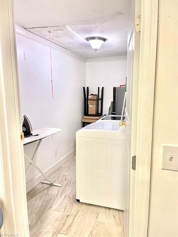 5385 Treetops Drive, Unit I Naples, FL 34113 - Photo 8 of 12 a utility room with dryer and washer