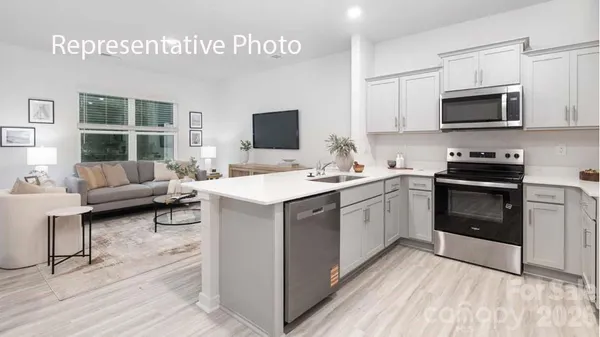 a kitchen with a sink stove and microwave