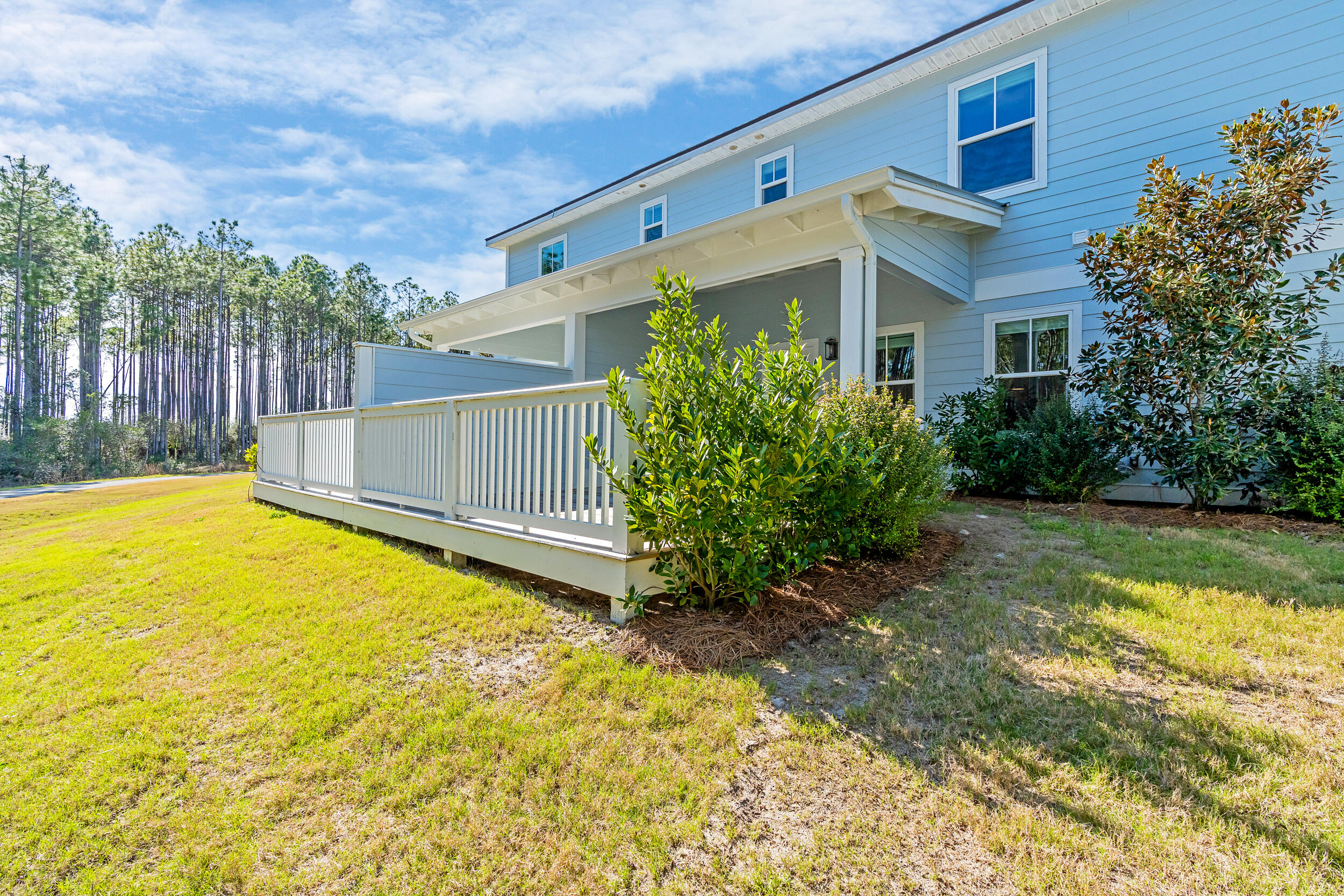 95 Golden Bell Ct Inlet Beach, Unit 95C Inlet Beach, FL 32461 - Photo 3 of 47 a view of a backyard with plants and wooden fence