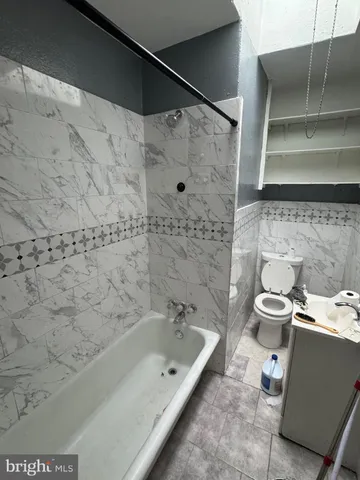 a bathroom with a bathtub and a toilet