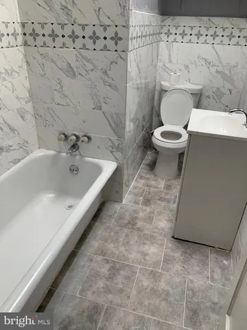 a bathroom with a toilet and a bathtub