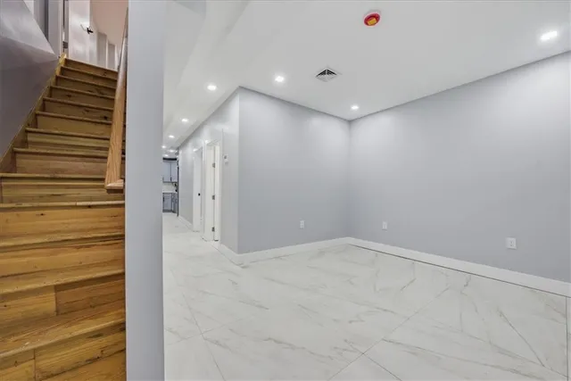 a view of a hallway with stairs