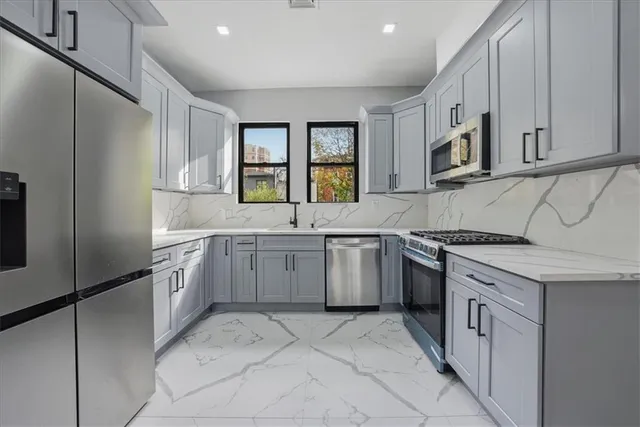 a kitchen with white cabinets and white appliances