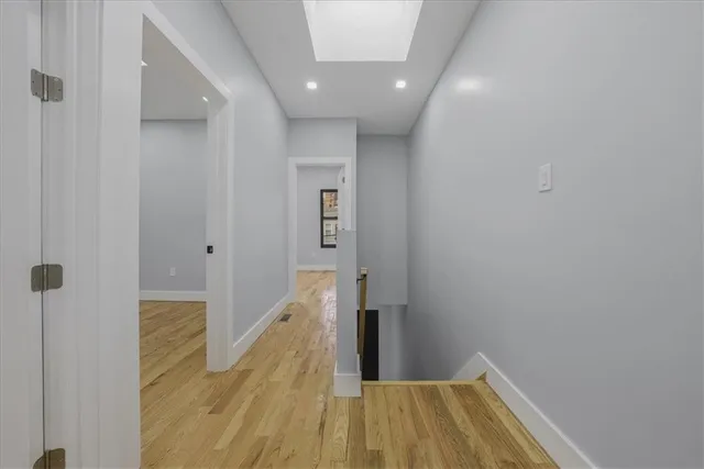 a view of a hallway with wooden floor