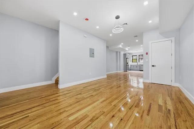 a view of a big room with wooden floor and natural light