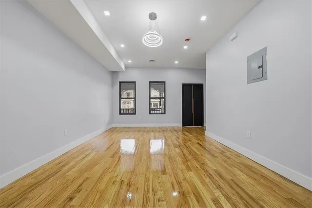 wooden floor in an empty room with a window