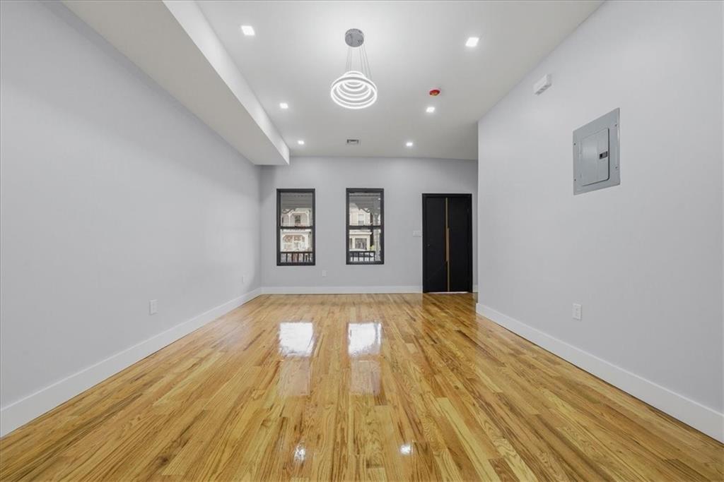 2862 Briggs Avenue Bronx, NY 10458 - Photo 29 of 38 wooden floor in an empty room with a window