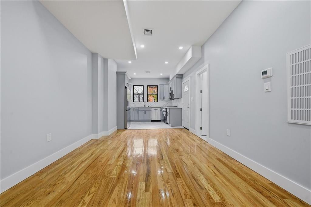 2862 Briggs Avenue Bronx, NY 10458 - Photo 30 of 38 a view of wooden floor in an empty room with a window