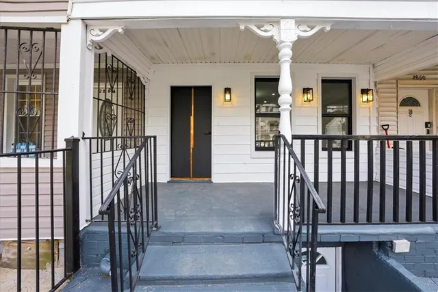 a view of staircase with railing and white walls